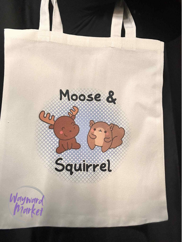 Tote bag with 'Moose & Squirrel' design and Wayward Market logo watermark.