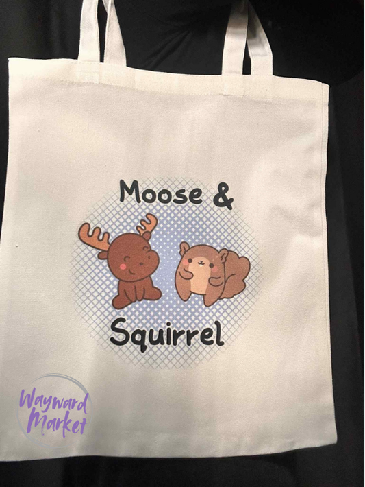 Tote bag with 'Moose & Squirrel' design and Wayward Market logo watermark.